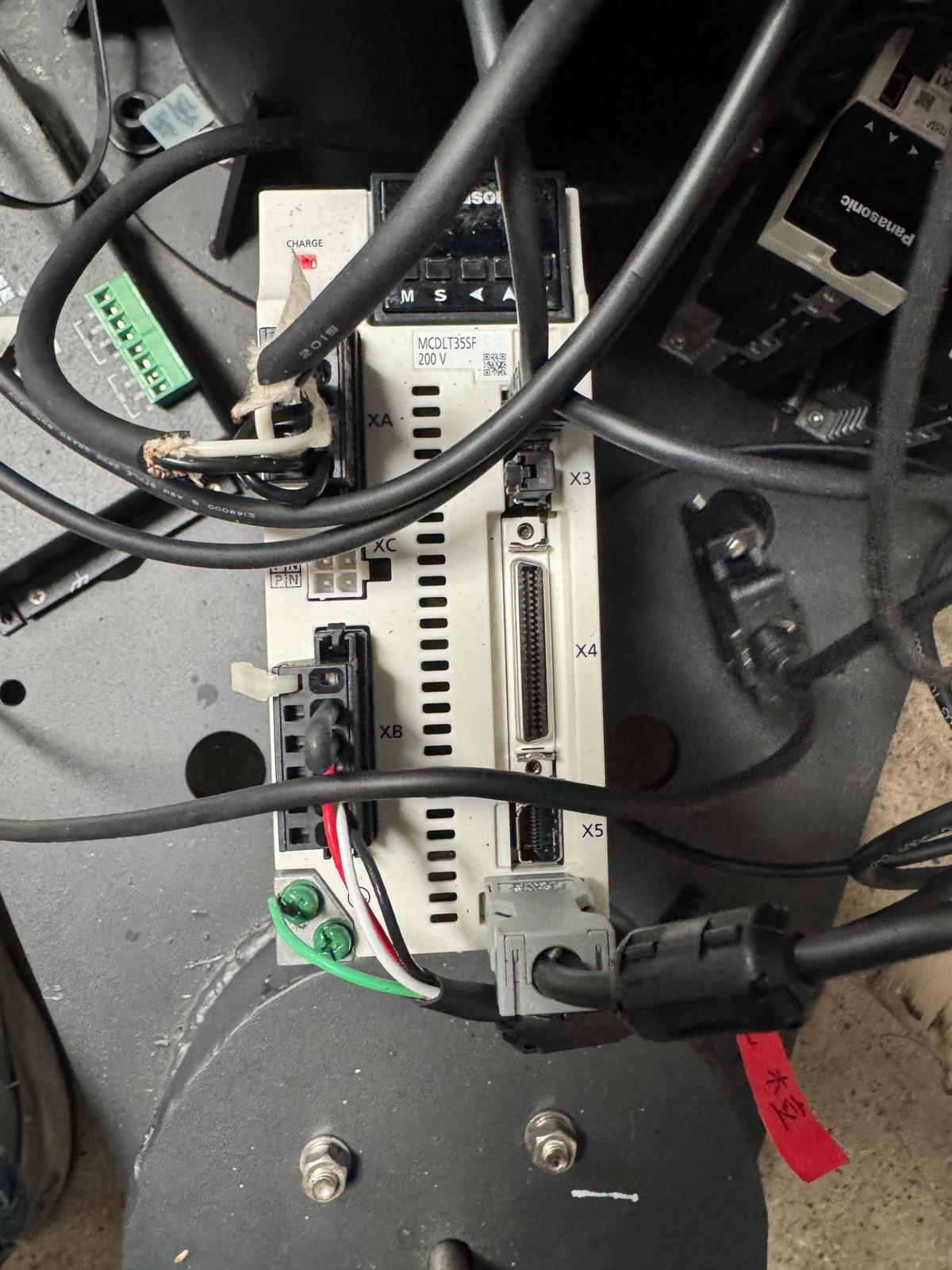 Image description: Panasonic servo driver connectors including XA, XB, XC, X3, X4, X5; X4 is discussed as the possible step/direction connector path to a QuadBox.